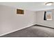 A versatile basement space offers ample potential, featuring carpeting and natural light at 6943 Ingalls St, Arvada, CO 80003
