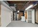 Unfinished basement with laundry and open ceiling at 6943 Ingalls St, Arvada, CO 80003