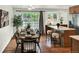 Bright dining area with hardwood floors, a table with seating for six, and backyard access at 6943 Ingalls St, Arvada, CO 80003