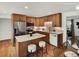 Modern kitchen with stainless steel appliances, a breakfast bar, tile backsplash, and lots of cabinets at 6943 Ingalls St, Arvada, CO 80003