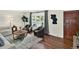 Cozy living room with hardwood floors, modern furniture, an area rug, and a wood door at 6943 Ingalls St, Arvada, CO 80003