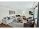 Bright living room with modern furniture, hardwood floors, area rug, and natural light at 6943 Ingalls St, Arvada, CO 80003
