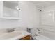 Clean bathroom with a single sink vanity, mirror, white tile, and tub with shower at 367 S Jasmine St, Denver, CO 80224