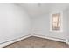 Bright bedroom features neutral carpet, paint, and trim, and a large window provides ample natural light at 367 S Jasmine St, Denver, CO 80224