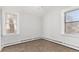 Bright bedroom features neutral carpet, paint, and trim, and two large windows provide ample natural light at 367 S Jasmine St, Denver, CO 80224