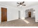 A spacious living room featuring neutral carpet, light-colored walls, with multiple doorways at 367 S Jasmine St, Denver, CO 80224