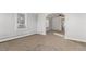 A spacious living room featuring neutral carpet, light-colored walls, and plenty of natural light at 367 S Jasmine St, Denver, CO 80224