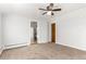 A spacious living room featuring neutral carpet, light-colored walls, and ceiling fan at 367 S Jasmine St, Denver, CO 80224