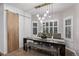 Elegant dining room with modern light fixture and sliding barn door at 10262 S Royal Eagle Ln, Highlands Ranch, CO 80129