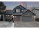 Charming two-story home featuring stone accents, gray siding, and a spacious two-car garage at 10262 S Royal Eagle Ln, Highlands Ranch, CO 80129