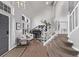 Bright and airy foyer featuring soaring ceilings, elegant staircase, and hardwood floors at 10262 S Royal Eagle Ln, Highlands Ranch, CO 80129