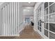 Bright hallway featuring modern staircase, hardwood floors, and glass doors at 10262 S Royal Eagle Ln, Highlands Ranch, CO 80129