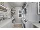 Bright laundry room with stacked washer and dryer and custom cabinets at 10262 S Royal Eagle Ln, Highlands Ranch, CO 80129