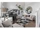 Stylish living room featuring hardwood floors, a grand piano, and comfortable seating at 10262 S Royal Eagle Ln, Highlands Ranch, CO 80129