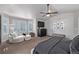 Relaxing main bedroom with a ceiling fan, natural light, and a cozy seating nook near the windows at 10262 S Royal Eagle Ln, Highlands Ranch, CO 80129