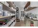 Well-organized pantry with wooden shelves and storage containers at 10262 S Royal Eagle Ln, Highlands Ranch, CO 80129