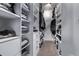 Organized walk-in closet with custom shelving, drawers, and ample space for clothing and accessories at 10262 S Royal Eagle Ln, Highlands Ranch, CO 80129