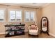 Comfortable bedroom with lots of natural light, a cozy chair, and a decorative mirror at 10751 Manorstone Dr, Highlands Ranch, CO 80126