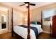 Bedroom featuring a four-poster bed, neutral walls, and an abundance of natural light at 10751 Manorstone Dr, Highlands Ranch, CO 80126