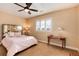 Bedroom with plantation shutters, neutral walls, and a decorative headboard at 10751 Manorstone Dr, Highlands Ranch, CO 80126