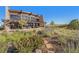 Stunning building exterior featuring a stone facade, large windows, and a pergola-covered patio at 10751 Manorstone Dr, Highlands Ranch, CO 80126