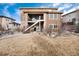 Two-story home with a walkout basement and backyard patio and staircase at 10751 Manorstone Dr, Highlands Ranch, CO 80126