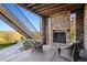 Relaxing covered patio boasts a stone fireplace and comfortable seating, perfect for outdoor enjoyment at 10751 Manorstone Dr, Highlands Ranch, CO 80126