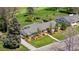 Lovely aerial view of home with manicured landscaping, driveway, and mature trees at 21 Fairway Ln, Littleton, CO 80123