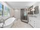 Elegant bathroom features a clawfoot tub, a modern shower, and stylish fixtures at 21 Fairway Ln, Littleton, CO 80123