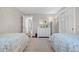 Shared ' bedroom featuring neutral walls, plush carpet, and access to bathroom at 21 Fairway Ln, Littleton, CO 80123
