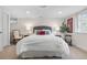 Cozy bedroom featuring a queen bed, soft lighting, and two decorative chairs at 21 Fairway Ln, Littleton, CO 80123