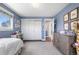 Bright bedroom with carpet, closet, natural light, and access to bathroom and hallway at 21 Fairway Ln, Littleton, CO 80123