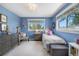 Charming blue bedroom featuring cozy accents, lots of natural light, and a window seat at 21 Fairway Ln, Littleton, CO 80123