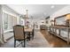 Bright dining room with wood floors, neutral rug, views of a large picturesque window, and chandelier at 21 Fairway Ln, Littleton, CO 80123