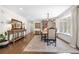 Elegant dining room with hardwood floors, chandelier, and a large window with natural light at 21 Fairway Ln, Littleton, CO 80123