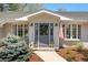 Inviting front entrance featuring a wreath, potted plants, and natural light at 21 Fairway Ln, Littleton, CO 80123