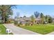 Beautiful home featuring a long driveway, mature trees, pristine landscaping and a well-manicured lawn at 21 Fairway Ln, Littleton, CO 80123