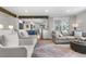 Open concept living room with views into the kitchen with an island and a fireplace and television at 21 Fairway Ln, Littleton, CO 80123