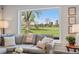 Inviting living room with expansive backyard view, a comfortable sectional sofa and neutral decor at 21 Fairway Ln, Littleton, CO 80123