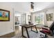 Inviting home office featuring a modern desk, French doors, and ample natural light at 21 Fairway Ln, Littleton, CO 80123