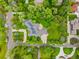 Sprawling property featuring a large home, outdoor patio, mature trees, and well-manicured lawns at 980 E Tufts Ave, Cherry Hills Village, CO 80113