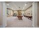 Large basement with a fireplace, game tables, and lots of guitars hanging on the wall at 980 E Tufts Ave, Cherry Hills Village, CO 80113