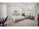 Well-lit bedroom featuring neutral carpet, a couch, and a desk near the window with views of the outside at 980 E Tufts Ave, Cherry Hills Village, CO 80113