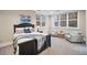 Comfortable bedroom with a black wood bed frame and large windows providing ample natural light at 980 E Tufts Ave, Cherry Hills Village, CO 80113