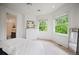 Bright bedroom with white walls, modern bed, and three windows overlooking greenery at 980 E Tufts Ave, Cherry Hills Village, CO 80113