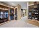 Spacious walk-in closet features custom shelving and storage for clothing and shoes at 980 E Tufts Ave, Cherry Hills Village, CO 80113