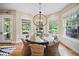 Charming dining area with wainscoting, a round table, and views of the outdoor patio at 980 E Tufts Ave, Cherry Hills Village, CO 80113