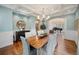 Dining room features coffered ceilings, hardwood floors, and view to grand piano at 980 E Tufts Ave, Cherry Hills Village, CO 80113
