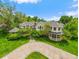 Stunning two-story home with beautifully landscaped grounds, circular driveway, and inviting architecture at 980 E Tufts Ave, Cherry Hills Village, CO 80113