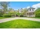 Charming two-story home featuring a manicured lawn, circular driveway, and a welcoming front porch at 980 E Tufts Ave, Cherry Hills Village, CO 80113